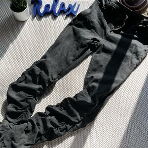 Stacked, washed Black denim pants.